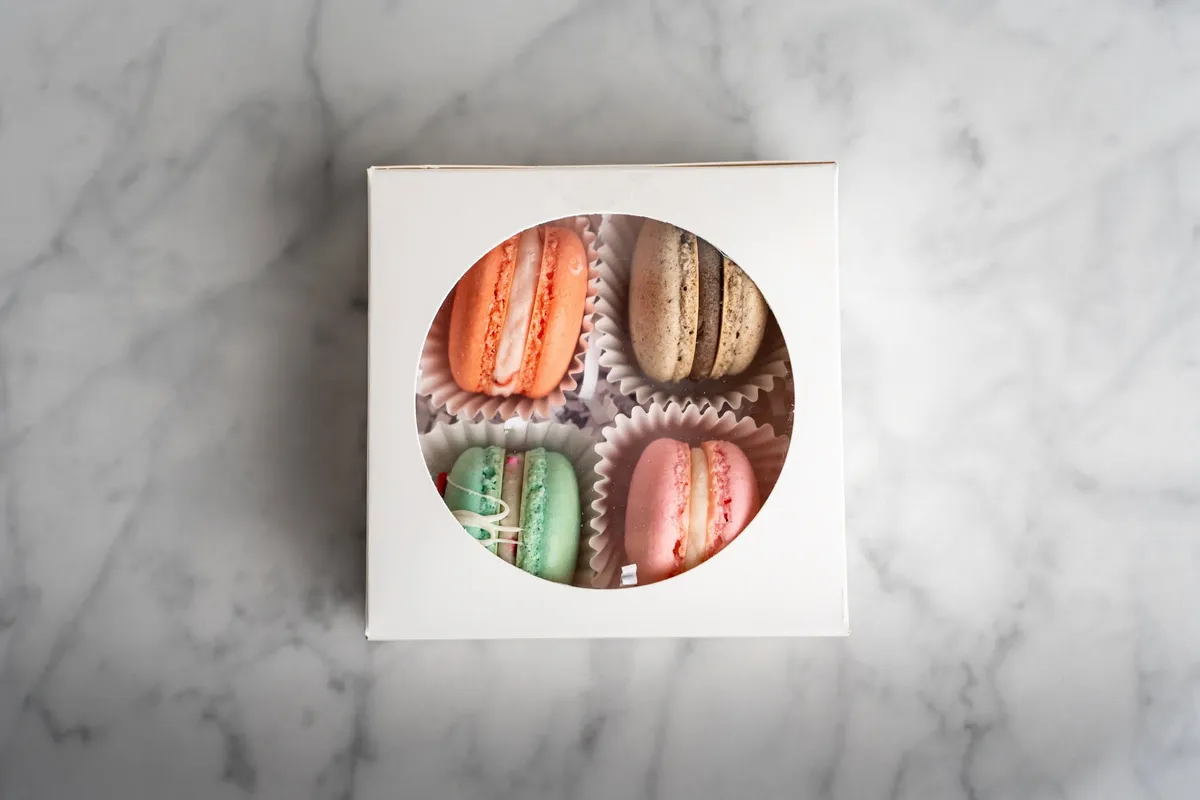 An assortment of macaron flavors in a gift box
