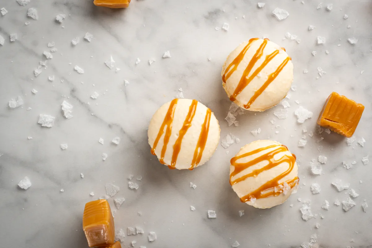 Salted caramel macarons with caramel drizzle and flaky sea salt