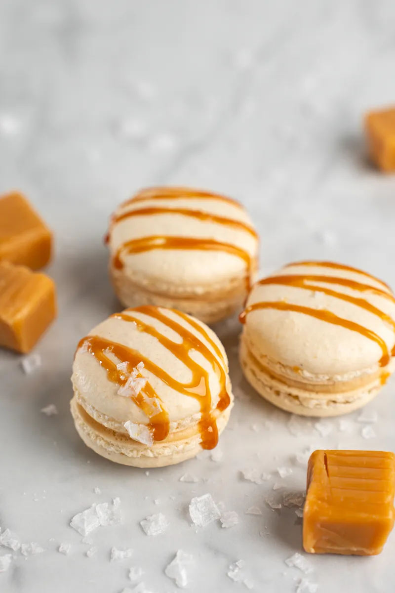 Salted caramel macarons with caramel drizzle and flaky sea salt