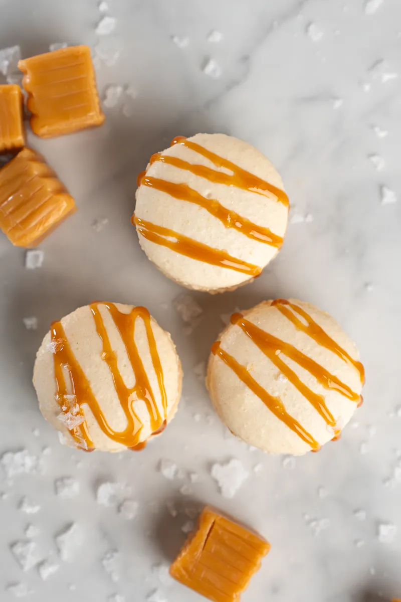 Salted caramel macarons with caramel drizzle and flaky sea salt