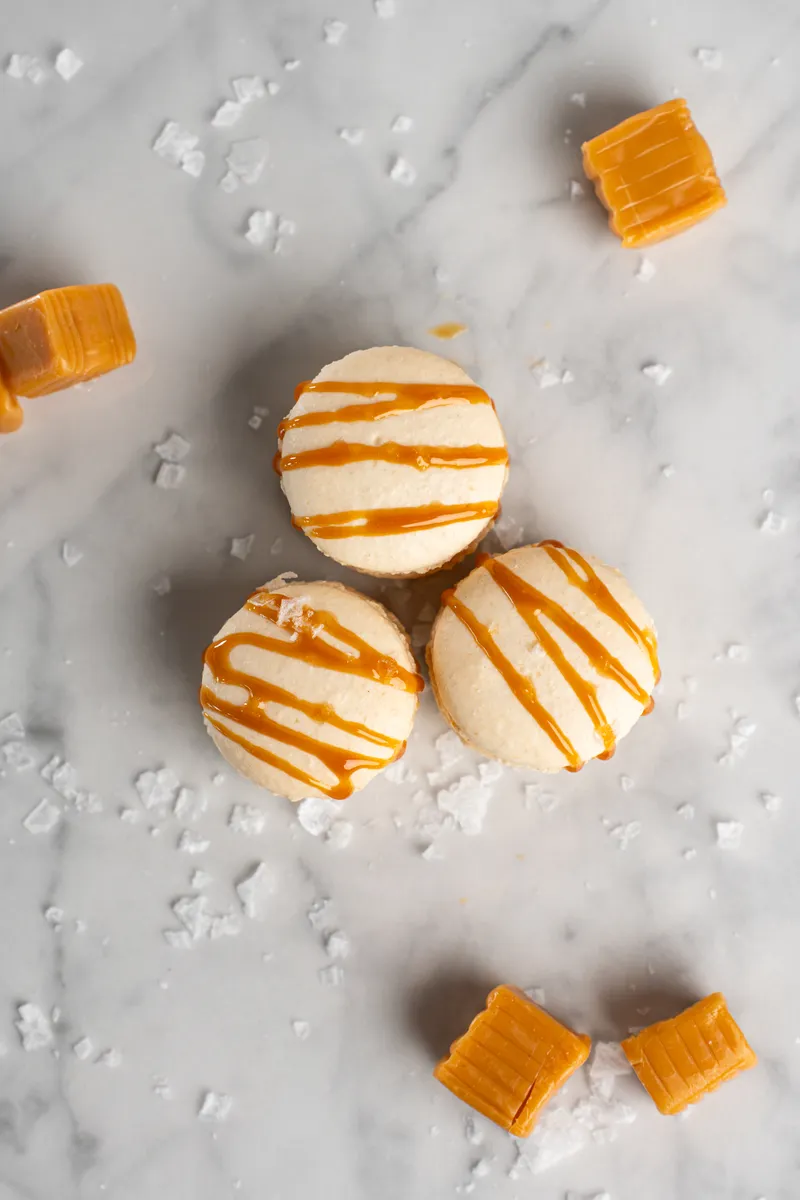 Salted caramel macarons with caramel drizzle and flaky sea salt